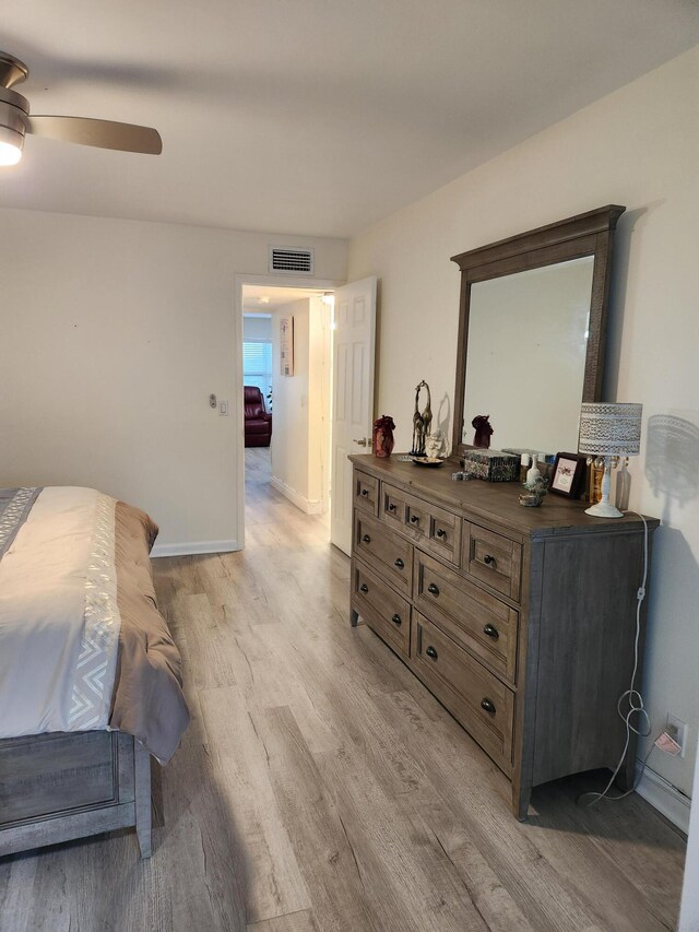 302 Wellington Unit B, West Palm Beach, FL 33417 - bedroom with light wood-style floors, a ceiling fan, and baseboards