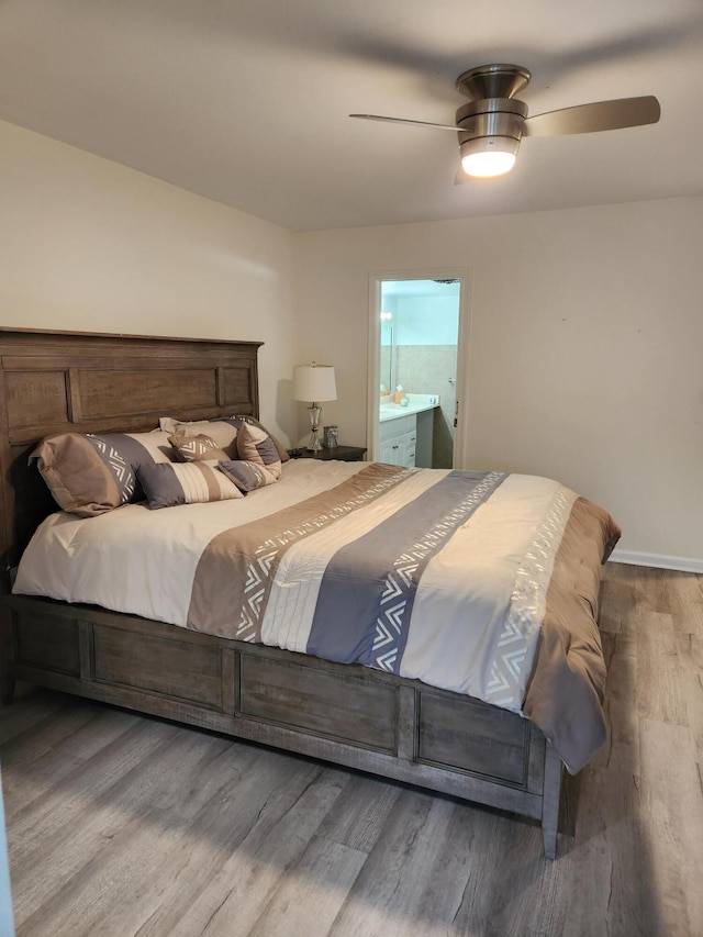 302 Wellington Unit B, West Palm Beach, FL 33417 - bedroom with wood finished floors, ensuite bath, and a ceiling fan