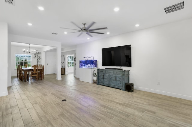 3974 SW Jarmer Rd, Port Saint Lucie, FL 34953 - living area with light wood finished floors, a chandelier, baseboards, ceiling fan, and recessed lighting