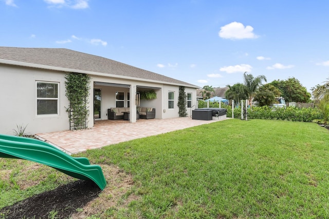 3974 SW Jarmer Rd, Port Saint Lucie, FL 34953 - view of grassy yard with an outdoor living space, a hot tub, a patio area, and a playground