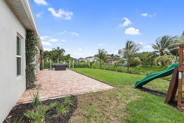 3974 SW Jarmer Rd, Port Saint Lucie, FL 34953 - view of green lawn featuring a playground and a patio area