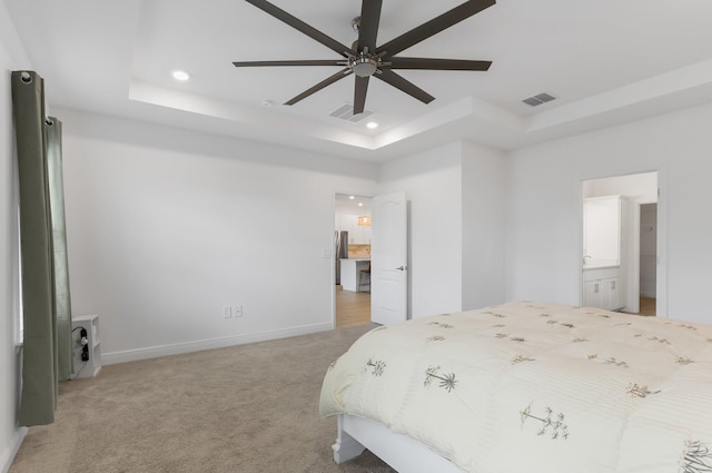 3974 SW Jarmer Rd, Port Saint Lucie, FL 34953 - bedroom featuring a raised ceiling, recessed lighting, light carpet, baseboards, and ensuite bath