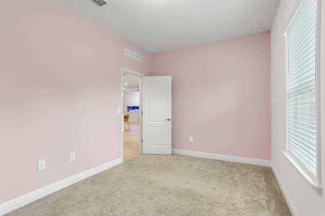 3974 SW Jarmer Rd, Port Saint Lucie, FL 34953 - unfurnished bedroom featuring light colored carpet, baseboards, and multiple windows