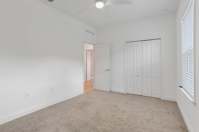 3974 SW Jarmer Rd, Port Saint Lucie, FL 34953 - unfurnished bedroom with carpet flooring, a closet, baseboards, and a ceiling fan