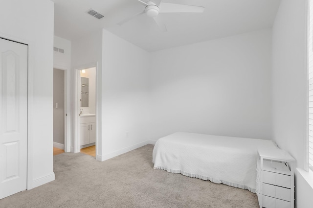 3974 SW Jarmer Rd, Port Saint Lucie, FL 34953 - bedroom with carpet, a sink, baseboards, ensuite bathroom, and ceiling fan