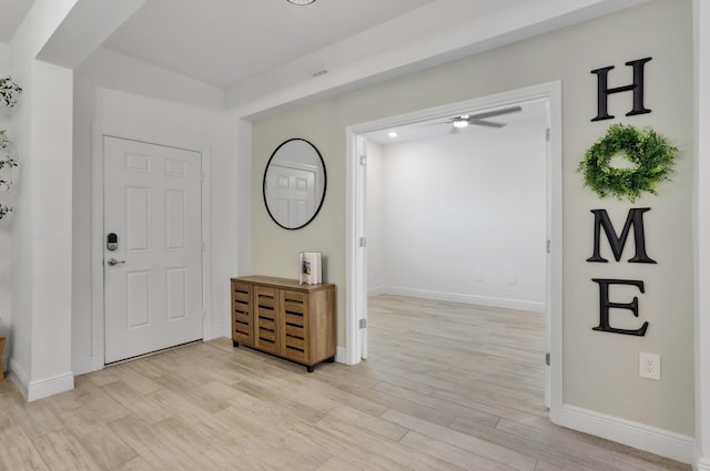 3974 SW Jarmer Rd, Port Saint Lucie, FL 34953 - foyer with light wood finished floors, baseboards, and ceiling fan