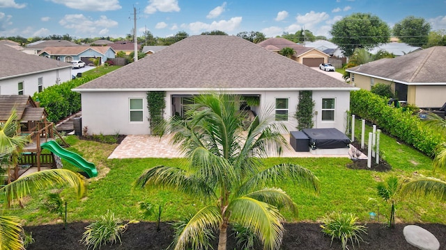 3974 SW Jarmer Rd, Port Saint Lucie, FL 34953 - back of house with roof with shingles, a hot tub, a patio, and a residential view