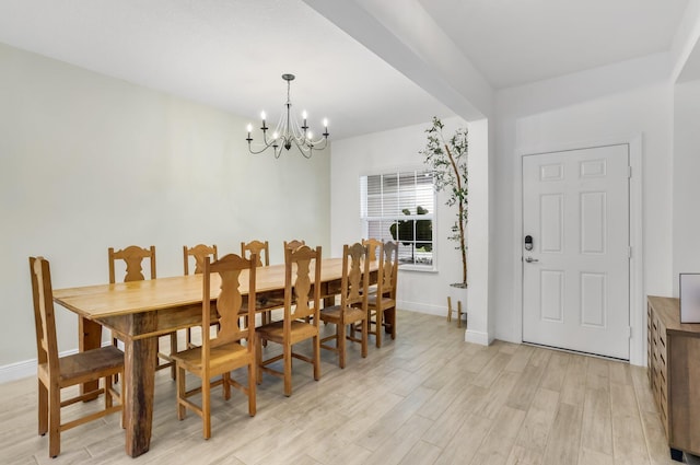 3974 SW Jarmer Rd, Port Saint Lucie, FL 34953 - dining area with a chandelier, light wood-type flooring, and baseboards