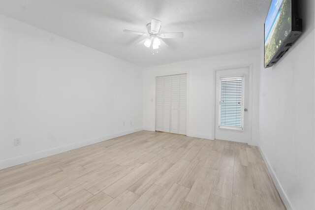 109 Wettaw Ln Unit 103, North Palm Beach, FL 33408 - unfurnished bedroom with light wood-style flooring, baseboards, and a ceiling fan