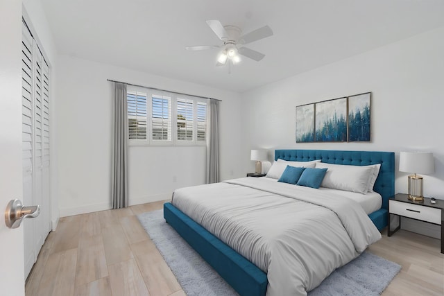 109 Wettaw Ln Unit 103, North Palm Beach, FL 33408 - bedroom with light wood-type flooring, a ceiling fan, and baseboards