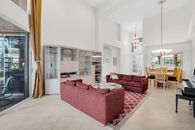 12373 Cascades Pointe Dr, Boca Raton, FL 33428 - living area featuring a chandelier, a high ceiling, arched walkways, and light tile patterned floors