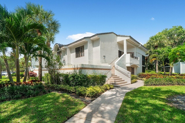15321 Strathearn Dr Unit 10902, Delray Beach, FL 33446 - view of front of house with stucco siding, a front lawn, and stairway