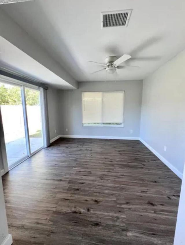 343 SE Husted Ter, Port Saint Lucie, FL 34983 - spare room featuring baseboards, a ceiling fan, and dark wood-style floors