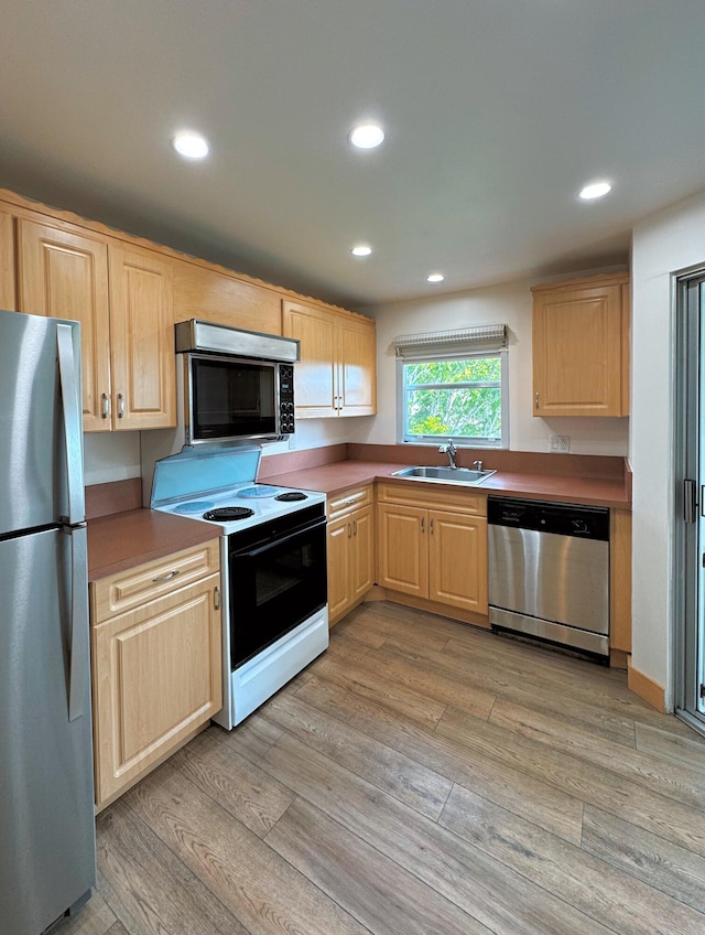 3524 Via Poinciana Unit 604, Greenacres, FL 33467 - kitchen featuring appliances with stainless steel finishes, light brown cabinets, a sink, recessed lighting, and light wood finished floors