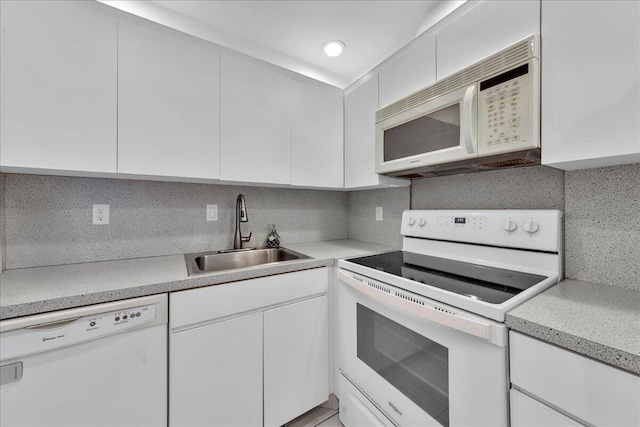 180 Cypress Club Dr Unit 813, Pompano Beach, FL 33060 - kitchen with white appliances, a sink, decorative backsplash, and white cabinets