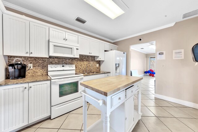 180 Cypress Club Dr Unit 813, Pompano Beach, FL 33060 - kitchen featuring white appliances, wood counters, a sink, crown molding, and backsplash