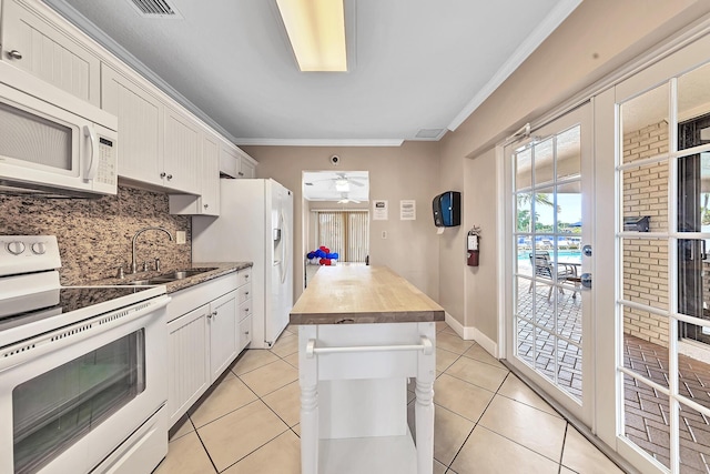 180 Cypress Club Dr Unit 813, Pompano Beach, FL 33060 - kitchen featuring white appliances, butcher block counters, a sink, ornamental molding, and backsplash