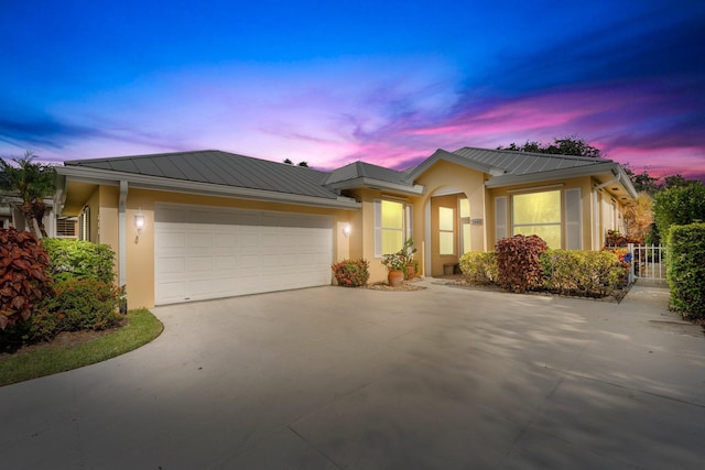 2683 SW Greenwich Way, Palm City, FL 34990 - single story home featuring stucco siding, an attached garage, metal roof, a standing seam roof, and concrete driveway