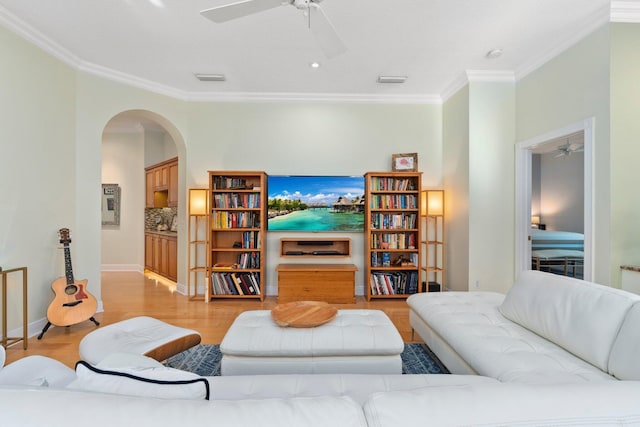 2683 SW Greenwich Way, Palm City, FL 34990 - living area featuring ceiling fan, arched walkways, crown molding, light wood-style flooring, and baseboards
