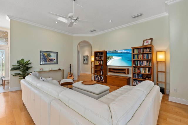 2683 SW Greenwich Way, Palm City, FL 34990 - living area featuring arched walkways, light wood-type flooring, baseboards, ornamental molding, and recessed lighting