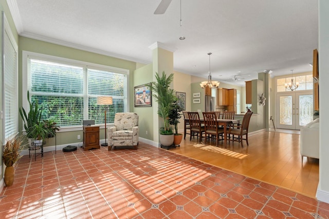 2683 SW Greenwich Way, Palm City, FL 34990 - living room with a chandelier, crown molding, ceiling fan, baseboards, and light tile patterned floors