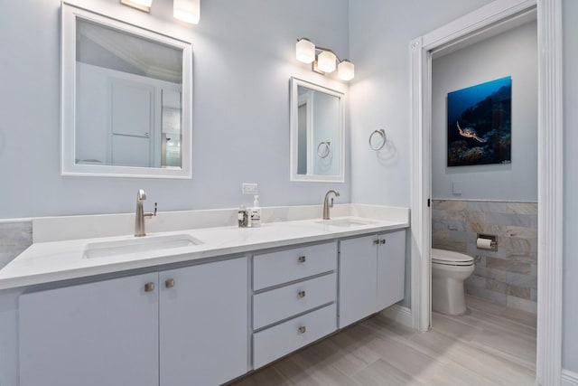 2683 SW Greenwich Way, Palm City, FL 34990 - full bath with toilet, double vanity, tile walls, and wainscoting