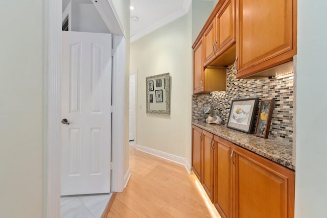 2683 SW Greenwich Way, Palm City, FL 34990 - hall with ornamental molding, baseboards, and light wood-style flooring