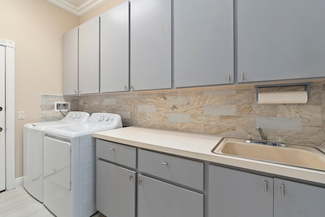 2683 SW Greenwich Way, Palm City, FL 34990 - washroom featuring cabinet space, washing machine and clothes dryer, and crown molding