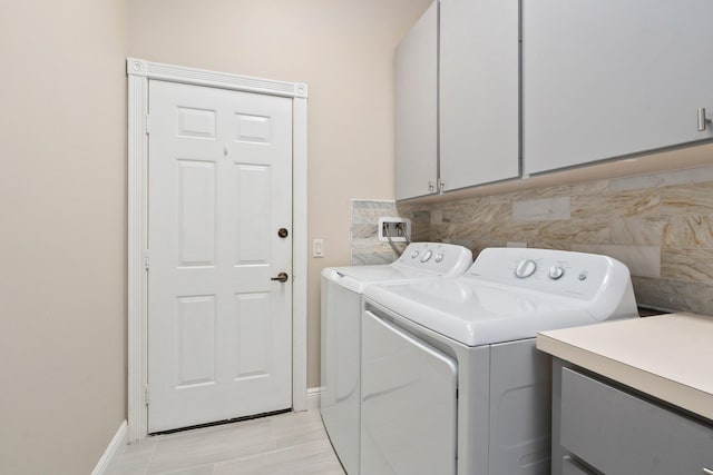 2683 SW Greenwich Way, Palm City, FL 34990 - laundry room with cabinet space, washing machine and dryer, and baseboards