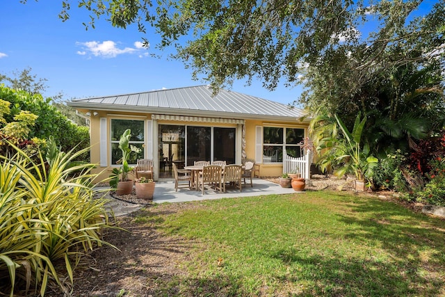 2683 SW Greenwich Way, Palm City, FL 34990 - rear view of property with metal roof, a patio area, a yard, and stucco siding