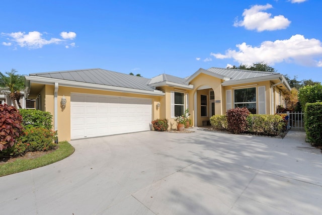 2683 SW Greenwich Way, Palm City, FL 34990 - ranch-style house featuring a standing seam roof, stucco siding, an attached garage, and metal roof