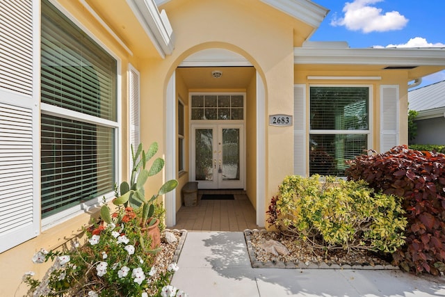 2683 SW Greenwich Way, Palm City, FL 34990 - view of exterior entry with french doors and stucco siding