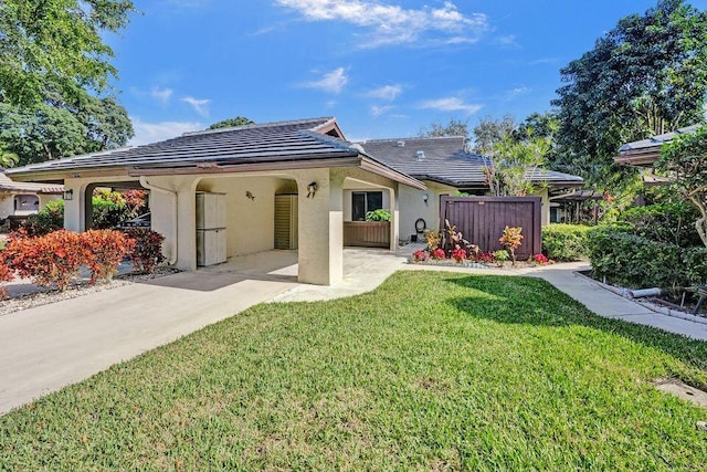 10112 Marwood Pl, Boynton Beach, FL 33437 - back of house with concrete driveway, an attached carport, and stucco siding