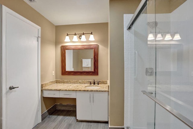 10112 Marwood Pl, Boynton Beach, FL 33437 - bathroom featuring a shower stall, vanity, wood finished floors, and baseboards