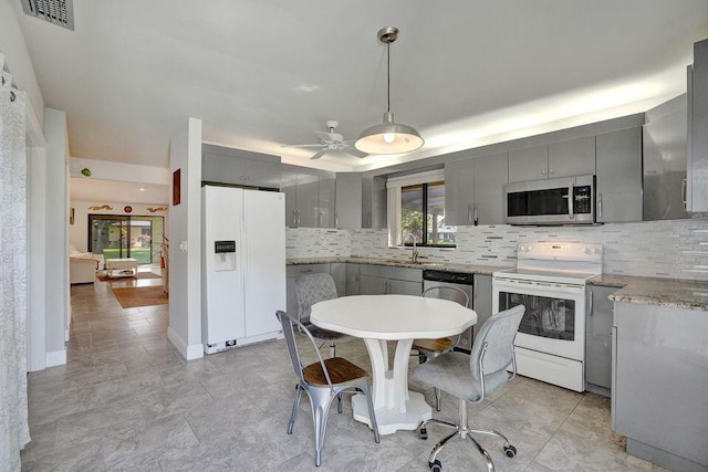 10112 Marwood Pl, Boynton Beach, FL 33437 - kitchen with appliances with stainless steel finishes, gray cabinetry, tasteful backsplash, decorative light fixtures, and a ceiling fan