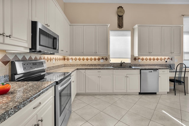 6908 Adriano Dr, Boynton Beach, FL 33437 - kitchen with stainless steel appliances, a sink, tasteful backsplash, dark stone counters, and light tile patterned floors