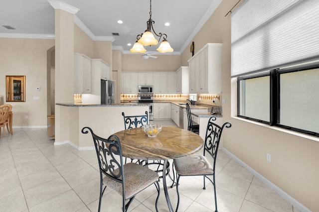 6908 Adriano Dr, Boynton Beach, FL 33437 - dining space with light tile patterned floors, a chandelier, ornamental molding, recessed lighting, and baseboards