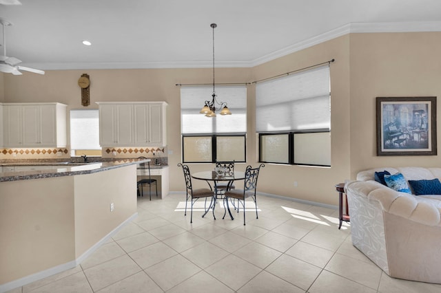 6908 Adriano Dr, Boynton Beach, FL 33437 - dining space featuring light tile patterned floors, a chandelier, crown molding, recessed lighting, and baseboards