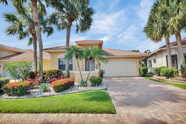 6908 Adriano Dr, Boynton Beach, FL 33437 - mediterranean / spanish-style house with a garage, stucco siding, a tiled roof, and decorative driveway