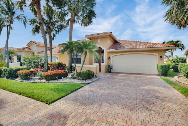 6908 Adriano Dr, Boynton Beach, FL 33437 - mediterranean / spanish-style house with a garage, decorative driveway, stucco siding, and a front yard