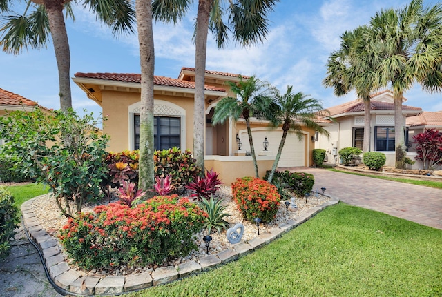 6908 Adriano Dr, Boynton Beach, FL 33437 - mediterranean / spanish house with an attached garage, stucco siding, driveway, a tile roof, and a front yard