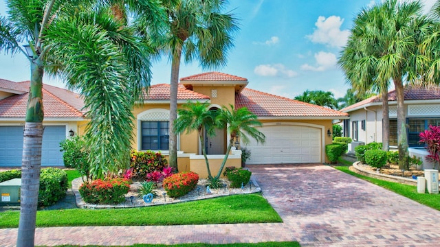 6908 Adriano Dr, Boynton Beach, FL 33437 - mediterranean / spanish house with stucco siding, a tile roof, a garage, and decorative driveway