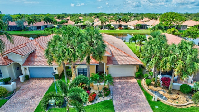 6908 Adriano Dr, Boynton Beach, FL 33437 - view of front facade with a tiled roof, decorative driveway, a residential view, and an attached garage