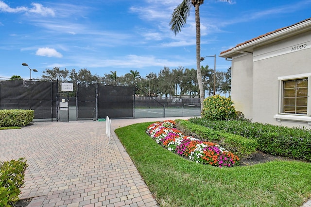 6908 Adriano Dr, Boynton Beach, FL 33437 - view of home's community with a tennis court and a gate