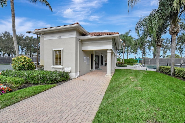 6908 Adriano Dr, Boynton Beach, FL 33437 - view of front of house with stucco siding, a tiled roof, and a patio