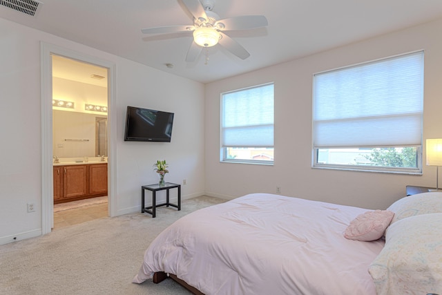 433 Amador Ln Unit 1, West Palm Beach, FL 33401 - bedroom featuring multiple windows, light colored carpet, connected bathroom, and baseboards
