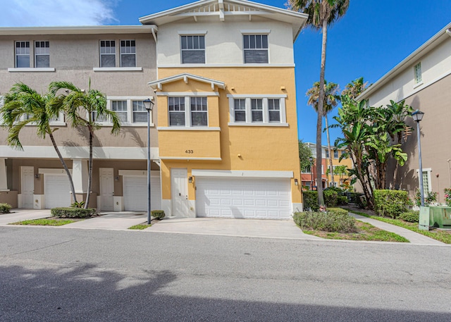 433 Amador Ln Unit 1, West Palm Beach, FL 33401 - multi unit property with stucco siding, a garage, and driveway