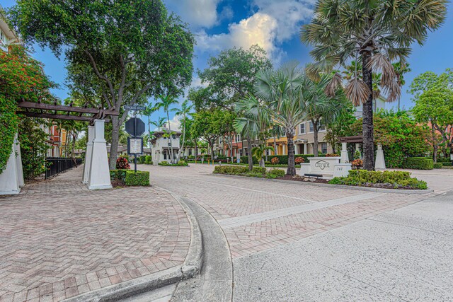 433 Amador Ln Unit 1, West Palm Beach, FL 33401 - view of decorative road with curbs, traffic signs, and a residential view