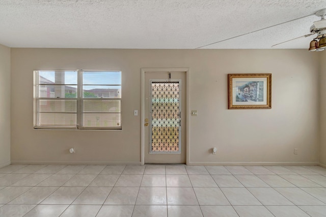 393 Fanshaw J, Boca Raton, FL 33434 - entrance foyer featuring a textured ceiling, light tile patterned floors, and baseboards