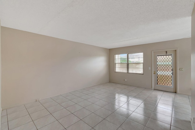 393 Fanshaw J, Boca Raton, FL 33434 - empty room featuring light tile patterned floors and a textured ceiling